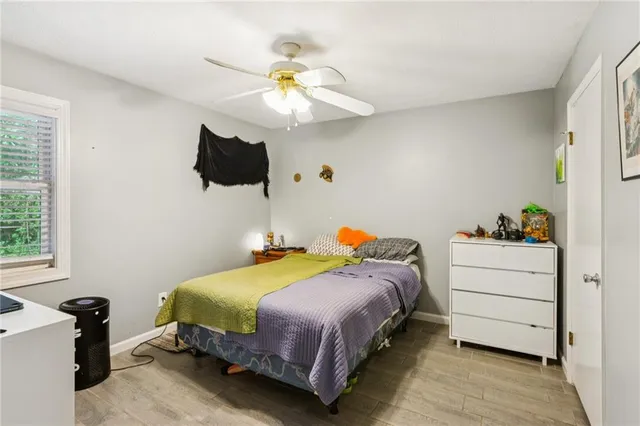 a bedroom with a bed and a window