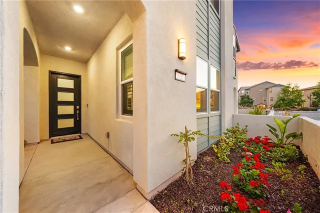 a front view of a house with a garden