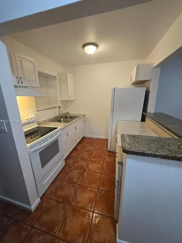 a kitchen with a stove and a sink