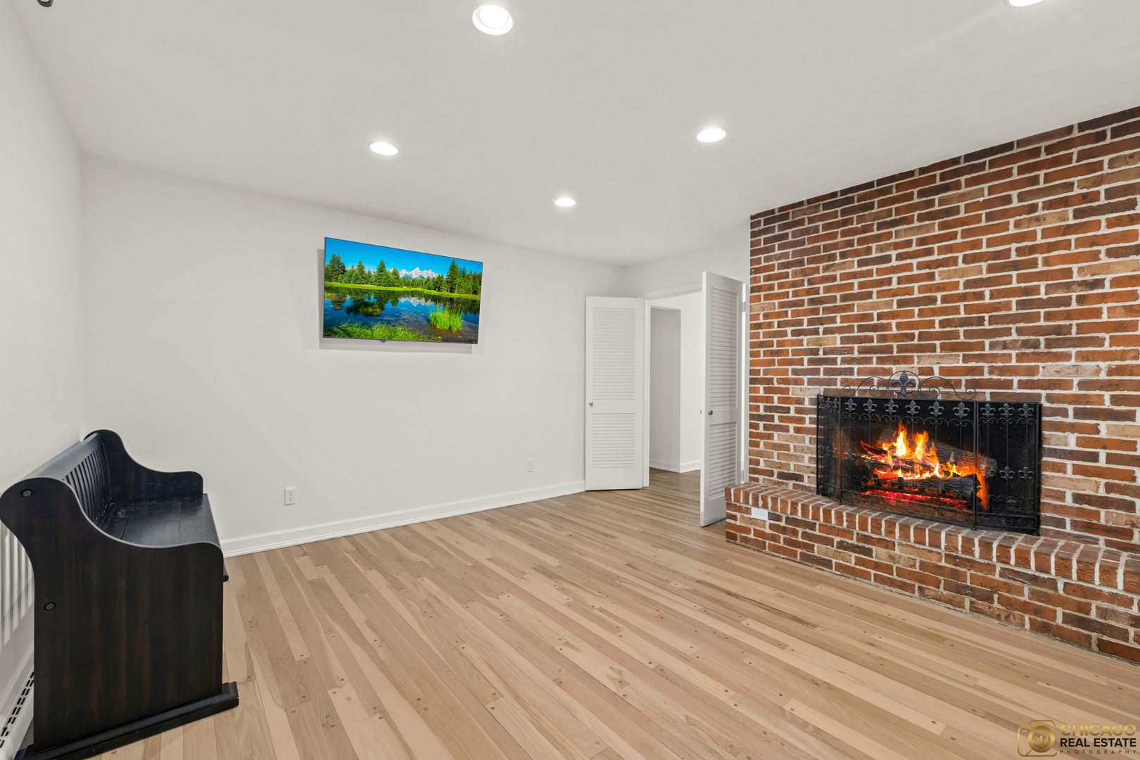 8019 South Malta Road DeKalb, IL 60115 - Photo 14 of 51 a room with a fireplace and a wooden floor