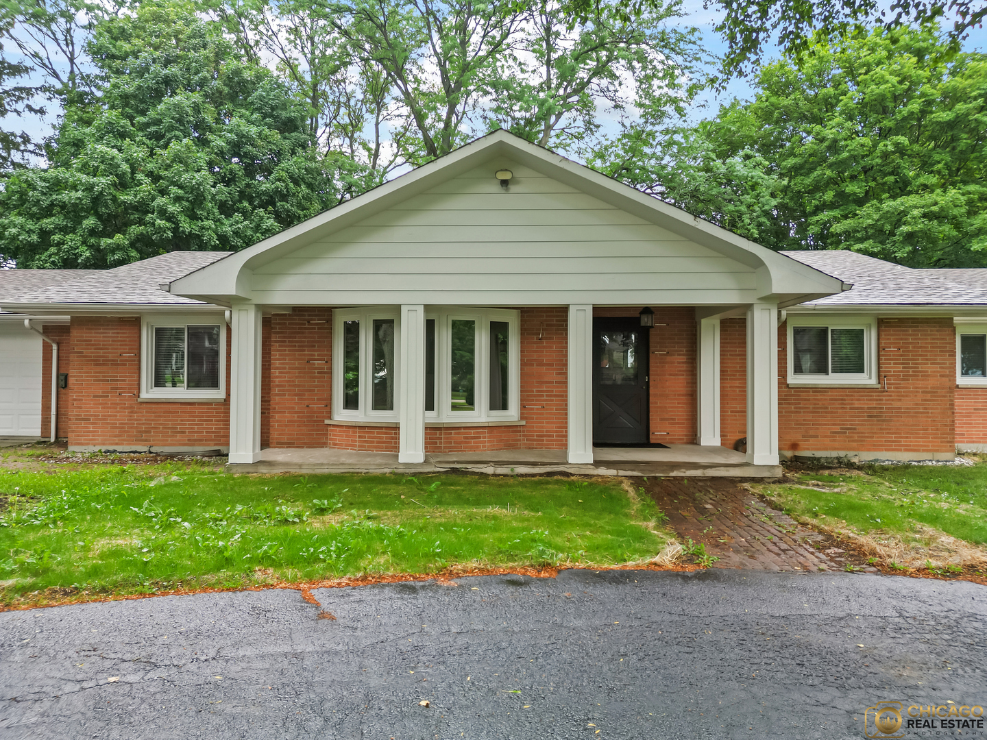 8019 South Malta Road DeKalb, IL 60115 - Photo 2 of 51 a front view of a house with a yard and garage