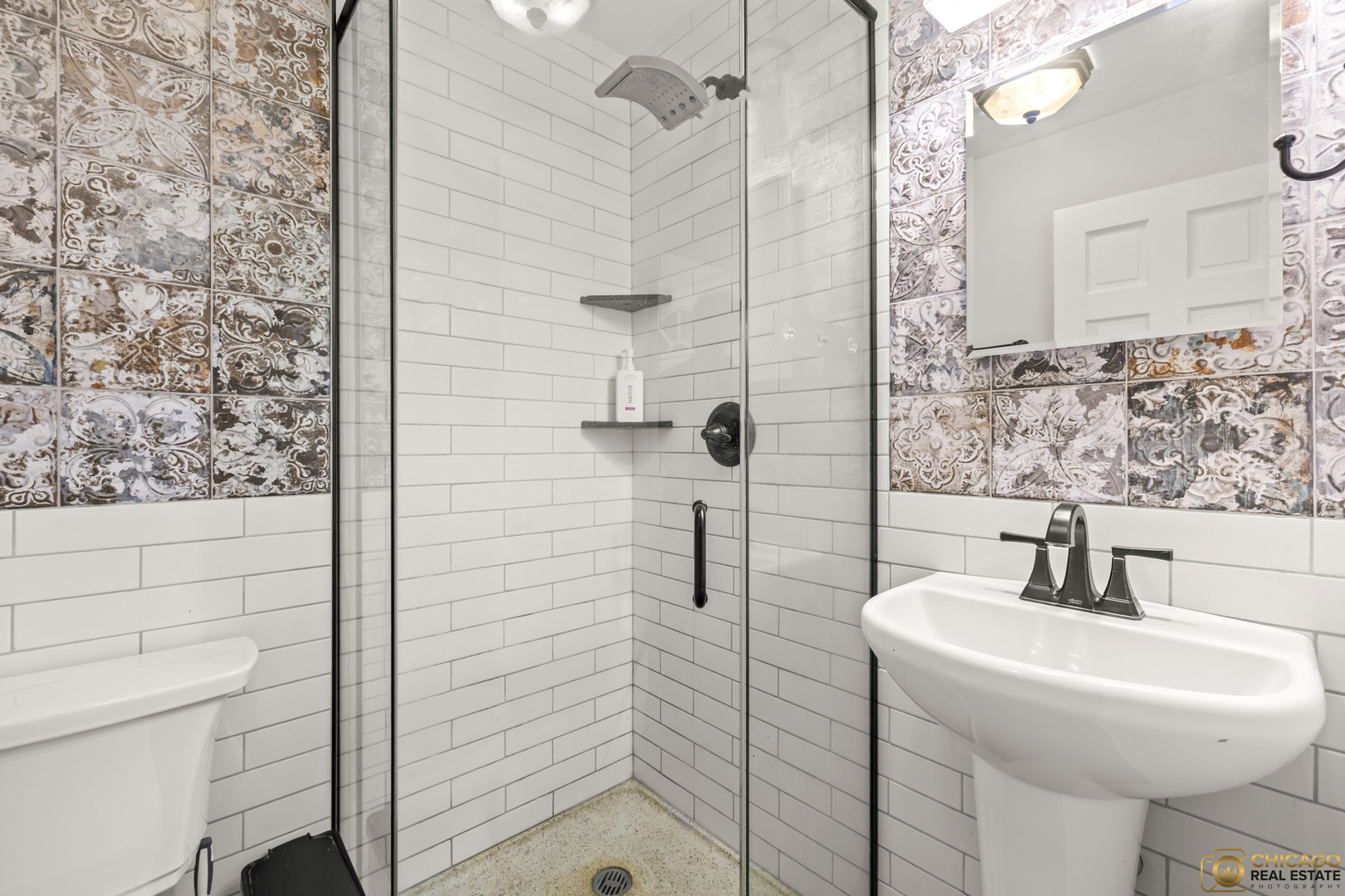 8019 South Malta Road DeKalb, IL 60115 - Photo 22 of 51 a bathroom with a sink a toilet and shower