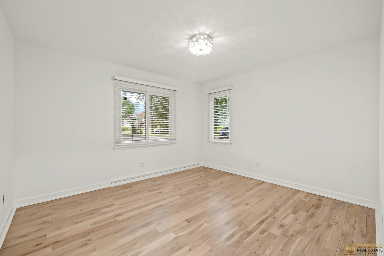8019 South Malta Road DeKalb, IL 60115 - Photo 23 of 51 an empty room with wooden floor and windows