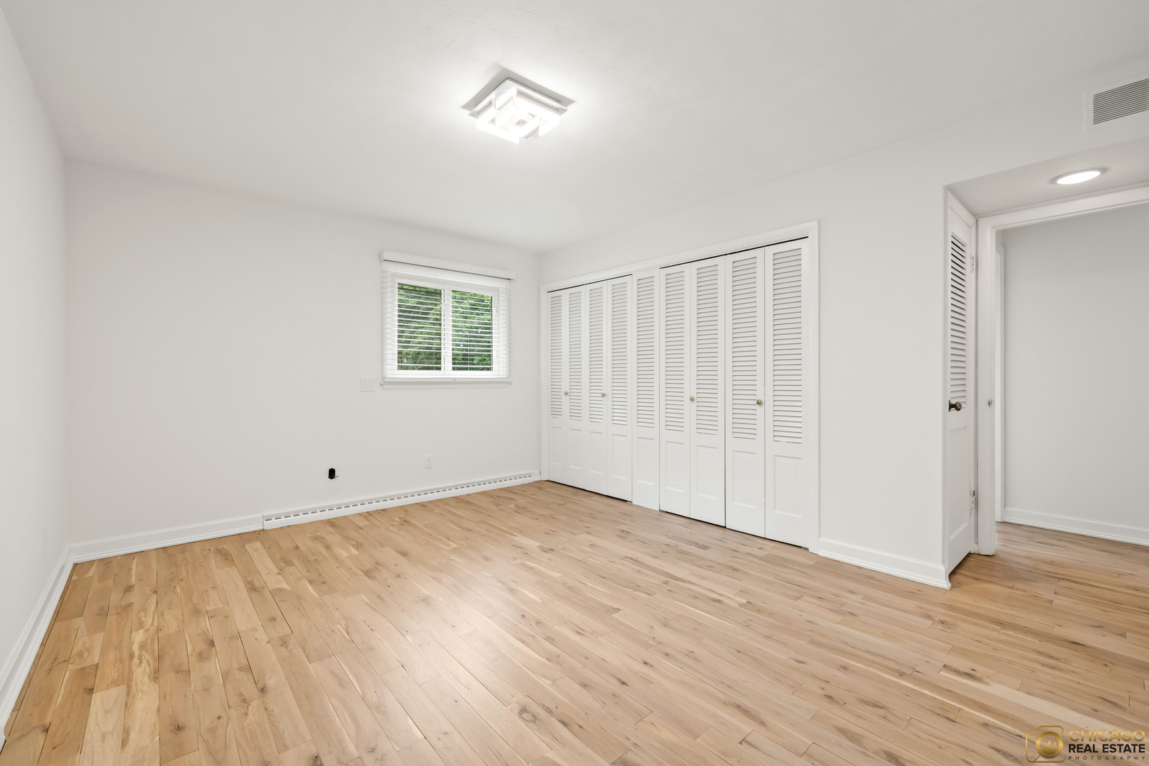 8019 South Malta Road DeKalb, IL 60115 - Photo 28 of 51 an empty room with wooden floor and windows