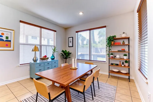 a dining room with furniture and wooden floor