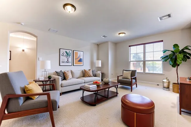 a living room with furniture potted plant and a window