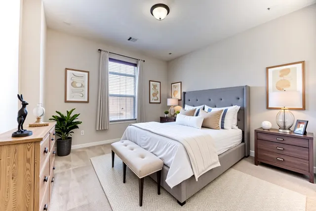 a bedroom with a bed and a potted plant