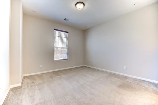 an empty room with windows and closet