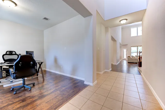 a view of a workspace with furniture and wooden floor