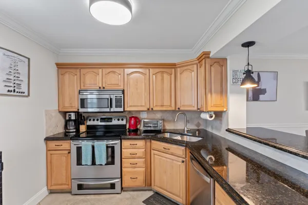 a kitchen with a stove a sink and a microwave