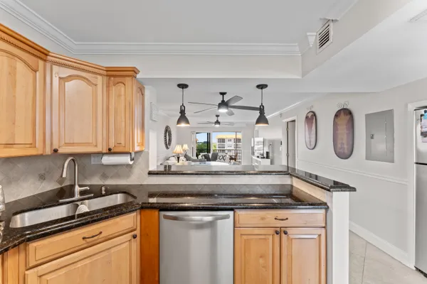 a kitchen with stainless steel appliances granite countertop a sink and cabinets