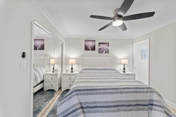 a spacious bedroom with a bed and a chandelier