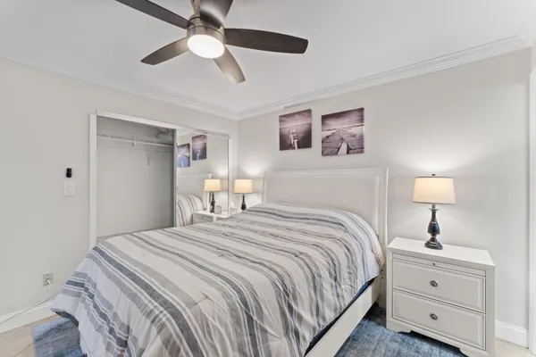 a bedroom with a bed and a lamp on a dresser