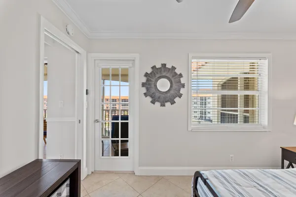 a view of a bedroom with wooden floor and windows