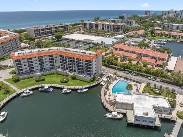 an aerial view of a house with a garden and lake view