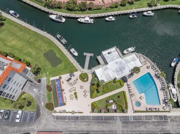 an aerial view of a house with a yard and lake view