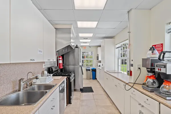 a kitchen that has a lot of cabinets and a sink