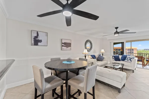 a view of a dining room with furniture and a chandelier