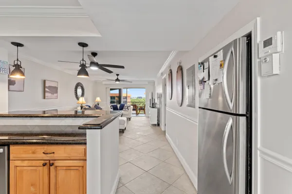 a kitchen with stainless steel appliances granite countertop a refrigerator a stove and a sink