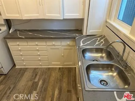 a kitchen with a sink and cabinets