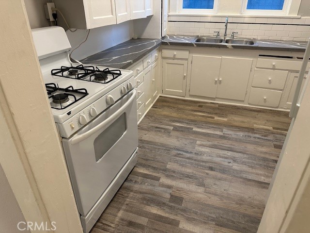 1025 Locust Avenue Long Beach, CA 90813 - Photo 15 of 64 a kitchen with granite countertop white cabinets and white appliances