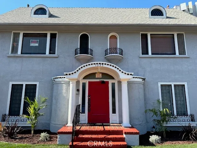 a front view of a house with garden