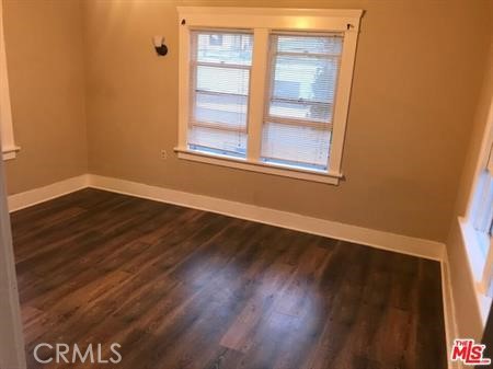 1025 Locust Avenue Long Beach, CA 90813 - Photo 28 of 64 a view of an empty room with wooden floor and a window