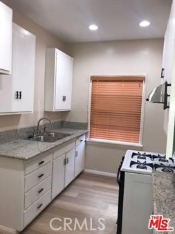 1025 Locust Avenue Long Beach, CA 90813 - Photo 30 of 64 a kitchen with stainless steel appliances granite countertop a sink stove and refrigerator