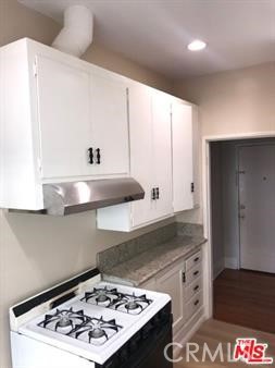 1025 Locust Avenue Long Beach, CA 90813 - Photo 31 of 64 a kitchen with a stove and a refrigerator