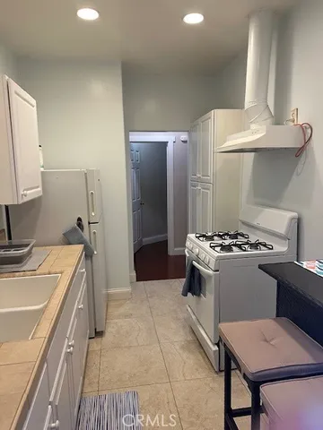 a view of an empty room with wooden floor closet and a ceiling fan