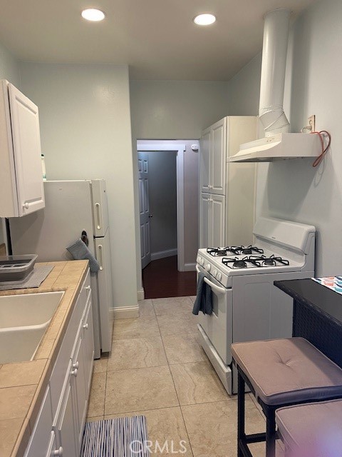 1025 Locust Avenue Long Beach, CA 90813 - Photo 33 of 64 a kitchen with stainless steel appliances granite countertop a sink stove and refrigerator