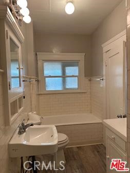 1025 Locust Avenue Long Beach, CA 90813 - Photo 45 of 64 a bathroom with a sink a toilet and shower