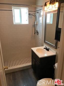 1025 Locust Avenue Long Beach, CA 90813 - Photo 47 of 64 a bathroom with a sink a toilet and a mirror