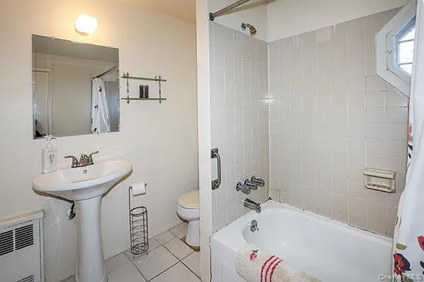 a bathroom with a sink mirror toilet and bathtub