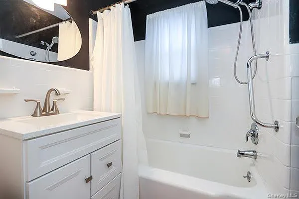 a bathroom with a sink a mirror and a shower