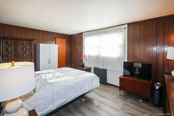 a bedroom with a bed and a television