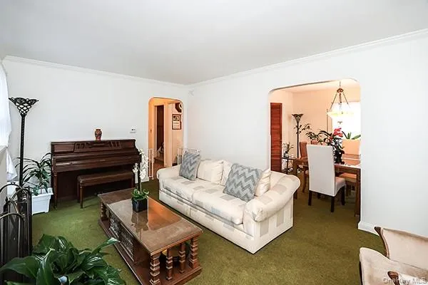 a living room with furniture and a piano