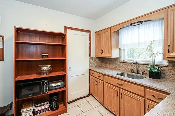 a kitchen with cabinets and window