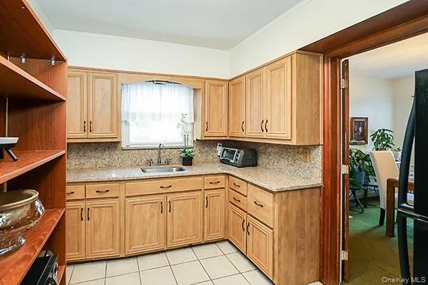a kitchen with white cabinets sink and white appliances