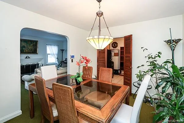 a view of a dining room with furniture and chandelier