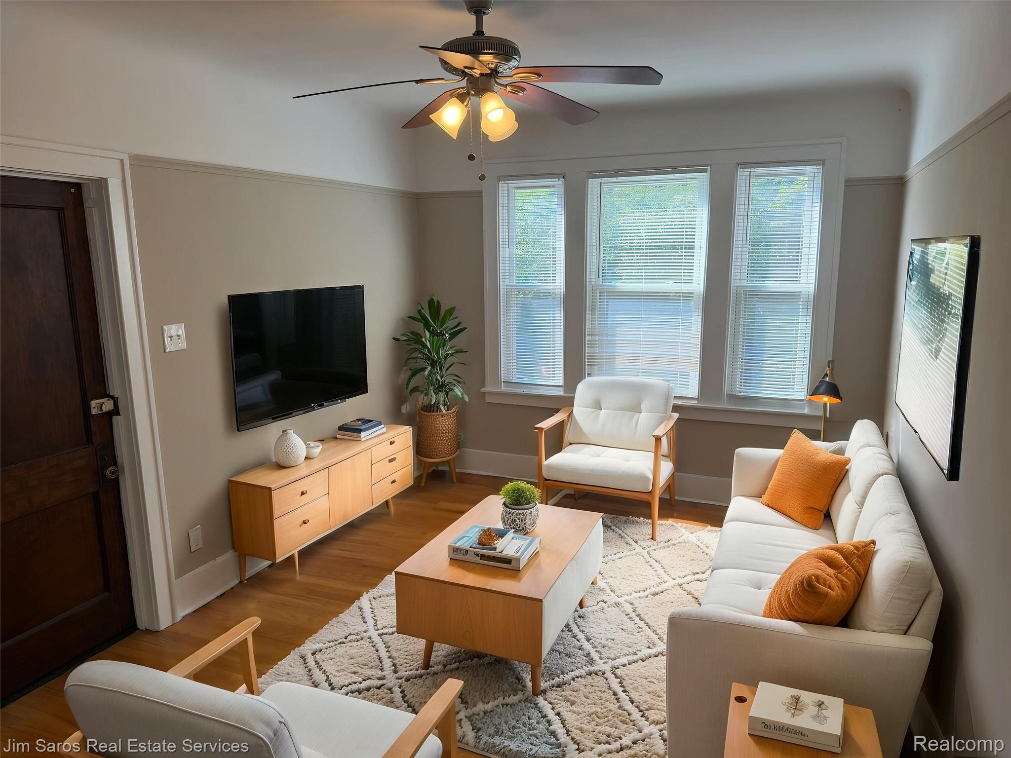 900 Nottingham Road, Unit 2 Grosse Pointe, MI 48230 - Photo 2 of 9 Living area featuring wood-finish flooring, a three-panel window with blinds, and a ceiling fan with integrated lighting