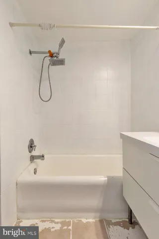 a bathroom with a bath tub with a shower
