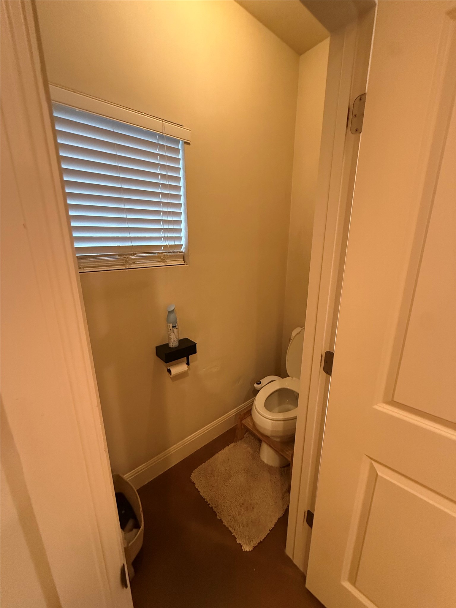 408 West Croslin Street Austin, TX 78752 - Photo 13 of 29 A compact, private half-bath features a window with blinds for natural light.