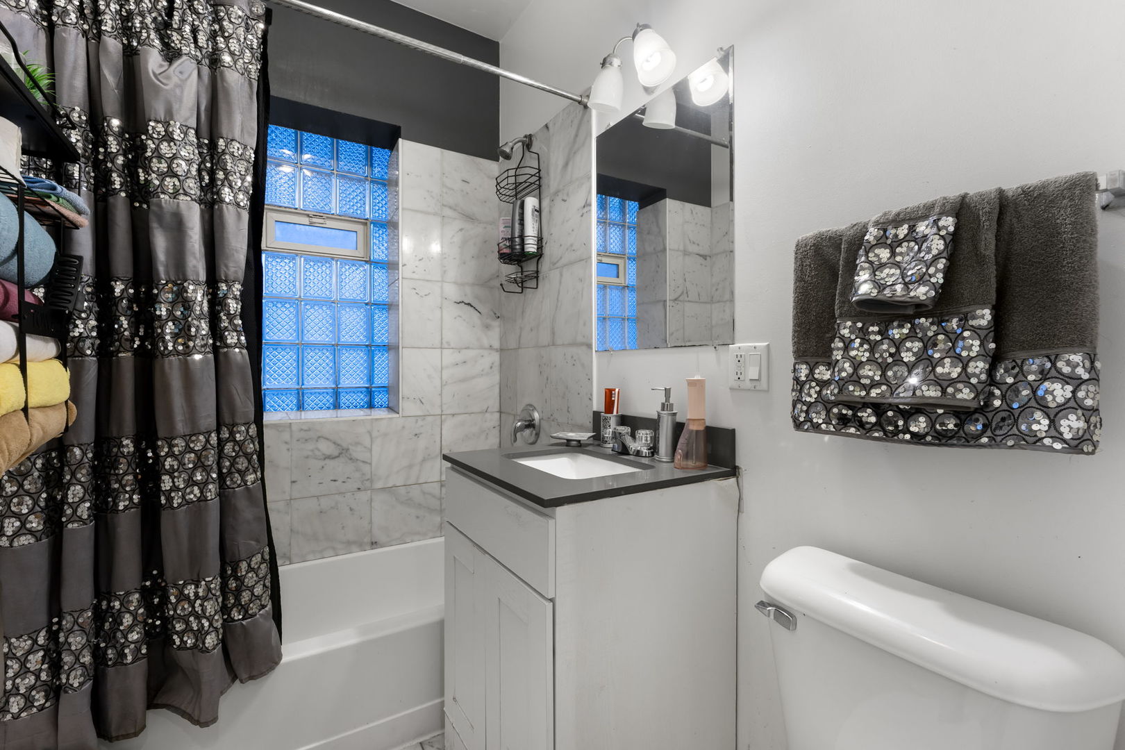12 North Mayfield Avenue, Unit 3N Chicago, IL 60644 - Photo 4 of 8 a bathroom with a sink toilet and shower