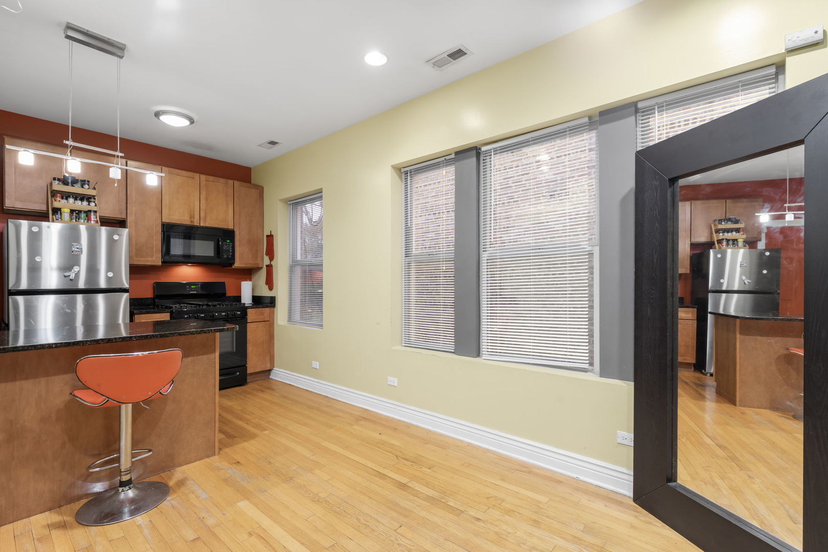 12 North Mayfield Avenue, Unit 3N Chicago, IL 60644 - Photo 5 of 8 a kitchen with granite countertop a refrigerator and a stove top oven