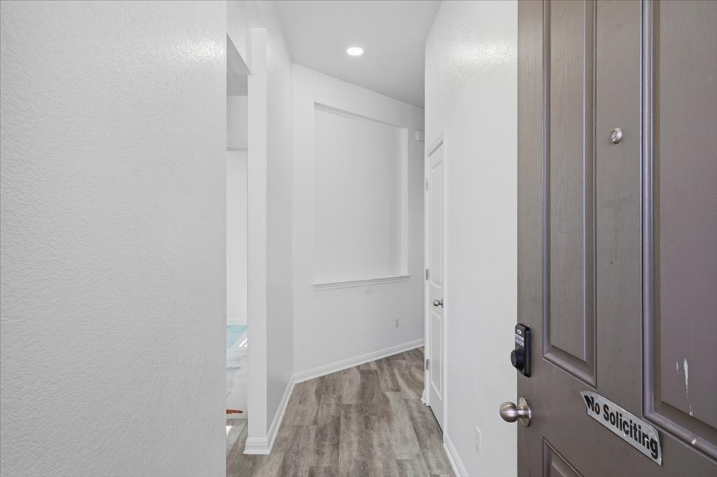 19040 Kimberlite Drive Pflugerville, TX 78660 - Photo 10 of 40 Corridor featuring light wood-type flooring, recessed lighting, and a textured wall