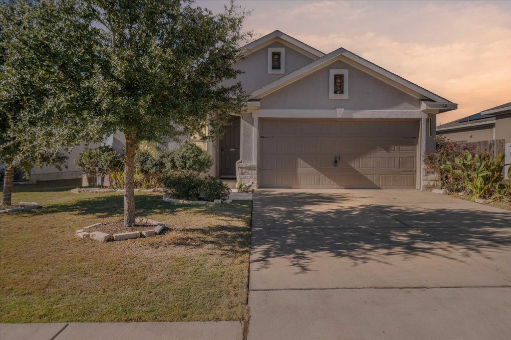 19040 Kimberlite Drive Pflugerville, TX 78660 - Photo 2 of 40 View of front of property with a lawn, concrete driveway, stucco siding, and a garage