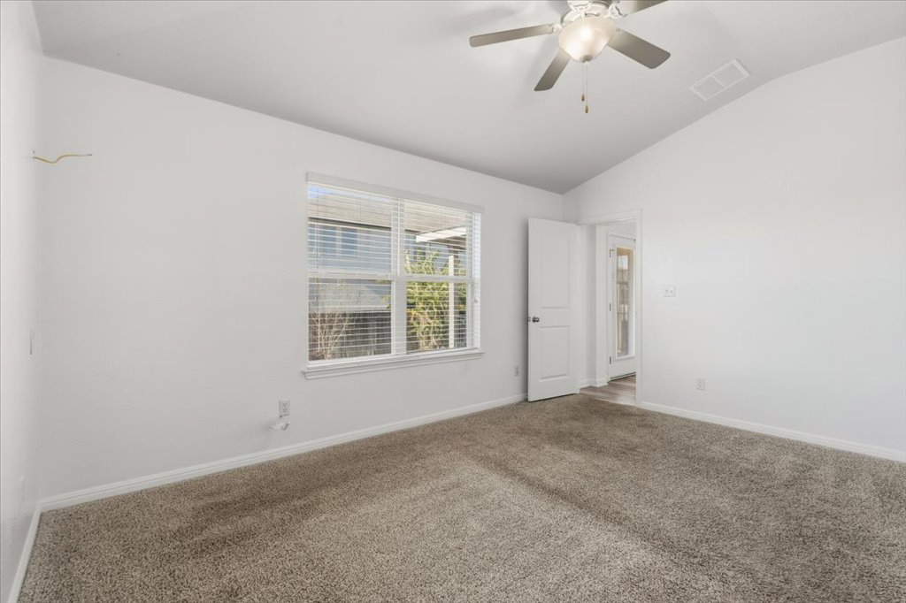 19040 Kimberlite Drive Pflugerville, TX 78660 - Photo 27 of 40 Empty room with lofted ceiling, carpet flooring, and a ceiling fan