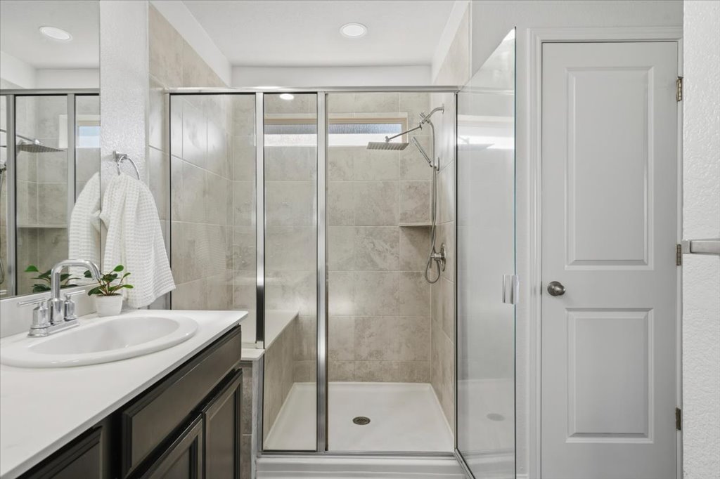 19040 Kimberlite Drive Pflugerville, TX 78660 - Photo 30 of 40 Full bathroom featuring vanity and a shower stall