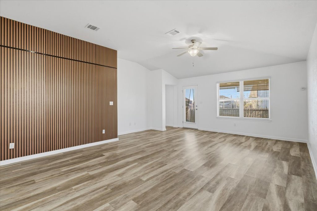 19040 Kimberlite Drive Pflugerville, TX 78660 - Photo 5 of 40 Unfurnished living room featuring light wood-style floors and ceiling fan